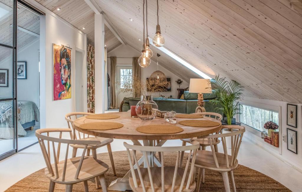 莱鲁姆Gorgeous Apartment In Lerum With Wifi的一间带木桌和椅子的用餐室