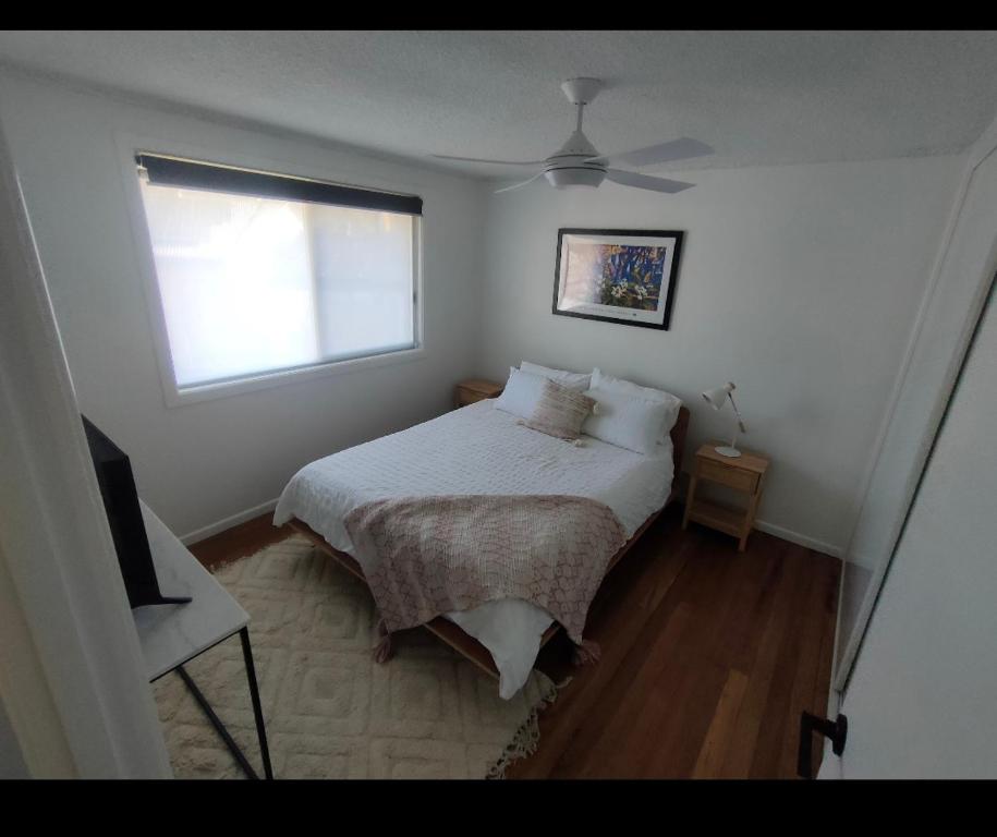 利斯莫尔Avondale Apartment的一间小卧室,配有床和窗户