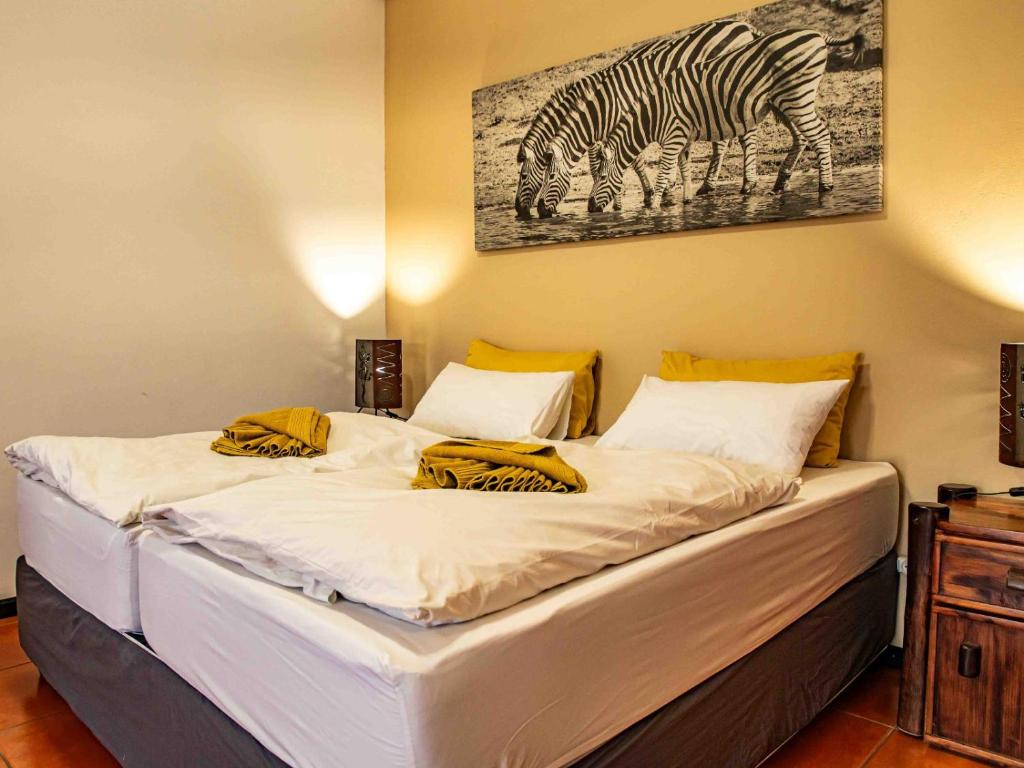斯瓦科普蒙德Bushbabies-Inn Self-Catering Accommodation的一间卧室,配有一张带斑马图的床铺