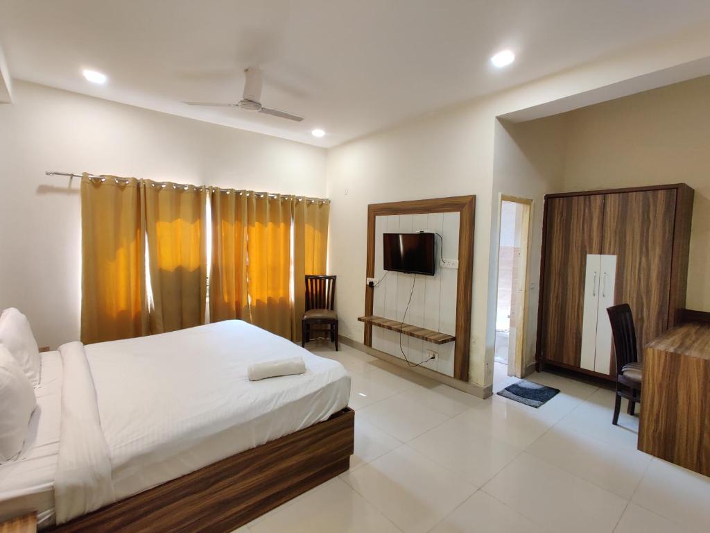 阿姆利则The Raj Darbar A Unit of Arora Hospitality的一间卧室配有一张床和一台电视