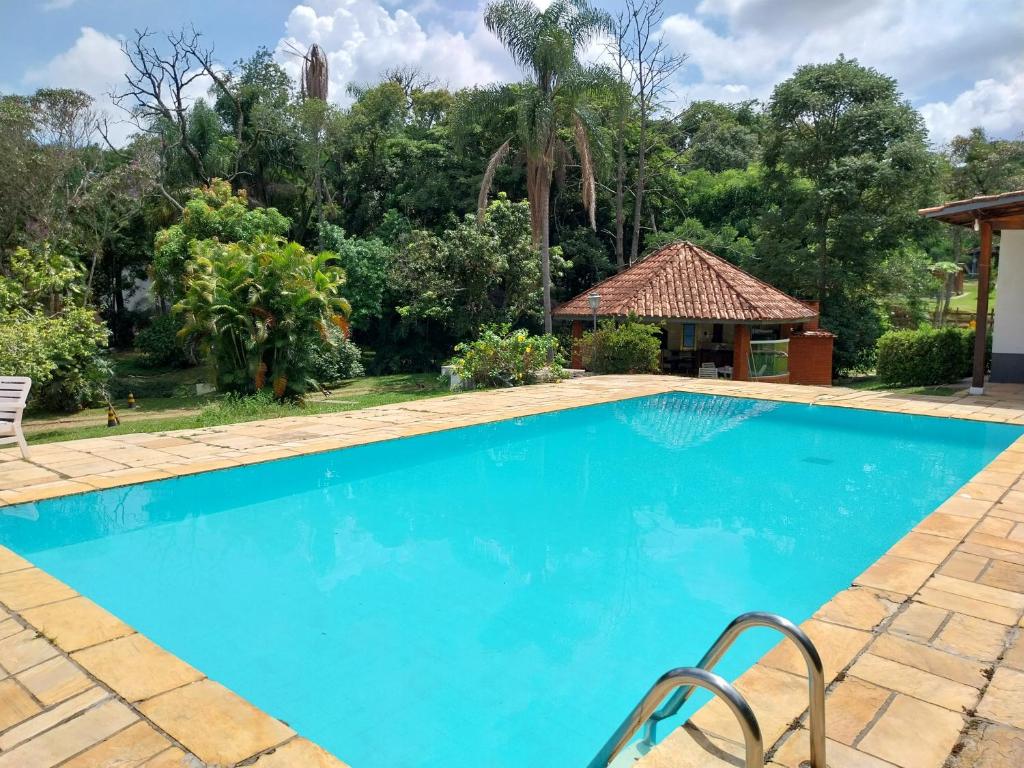 伊图佩瓦Chacara Recanto Paraíso Guacuri 2的一个带凉亭和树木的蓝色游泳池