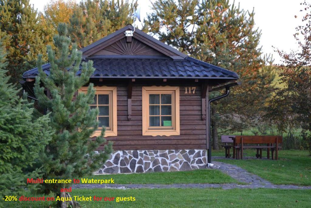 利普托斯基米库拉斯Holiday Home Tatralandia的庭院中带长凳的小小木屋
