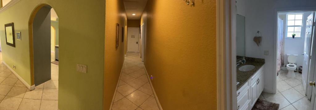 圣露西港Cwonders near midflorida event center and stadium的浴室的走廊上设有黄色的墙壁