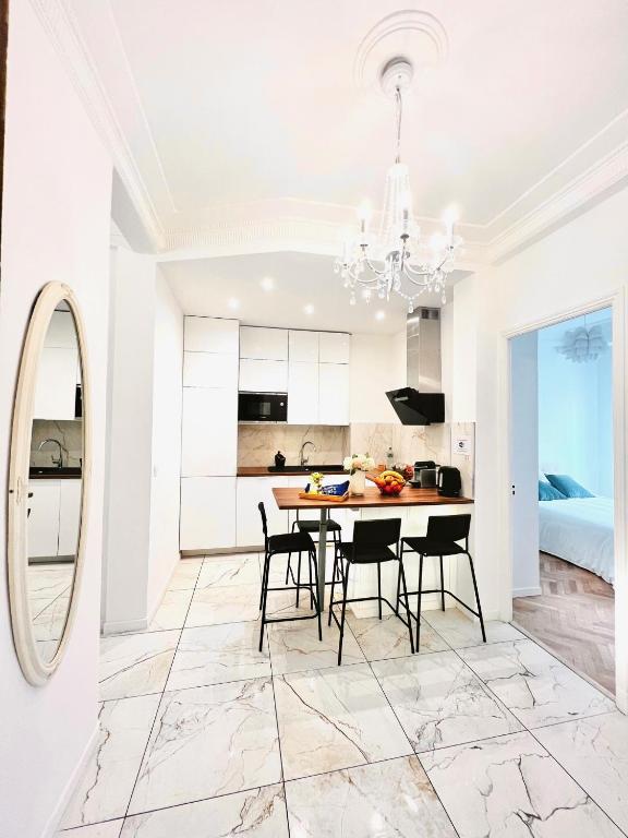 尼斯Cœur d&#39;Azur Appartement的配有桌椅的厨房和餐厅