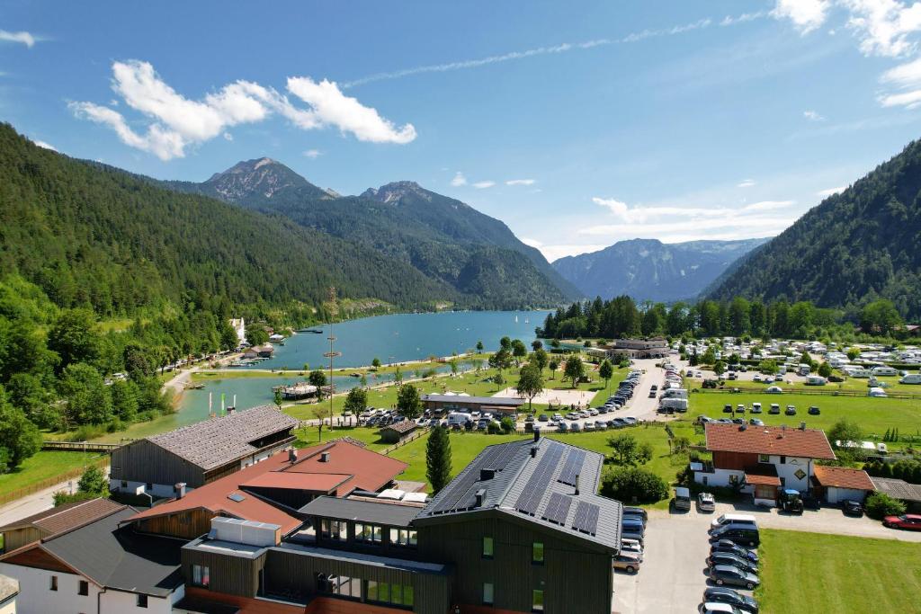 阿亨基希Karlingerhof的享有湖泊和山脉的度假村的空中景致