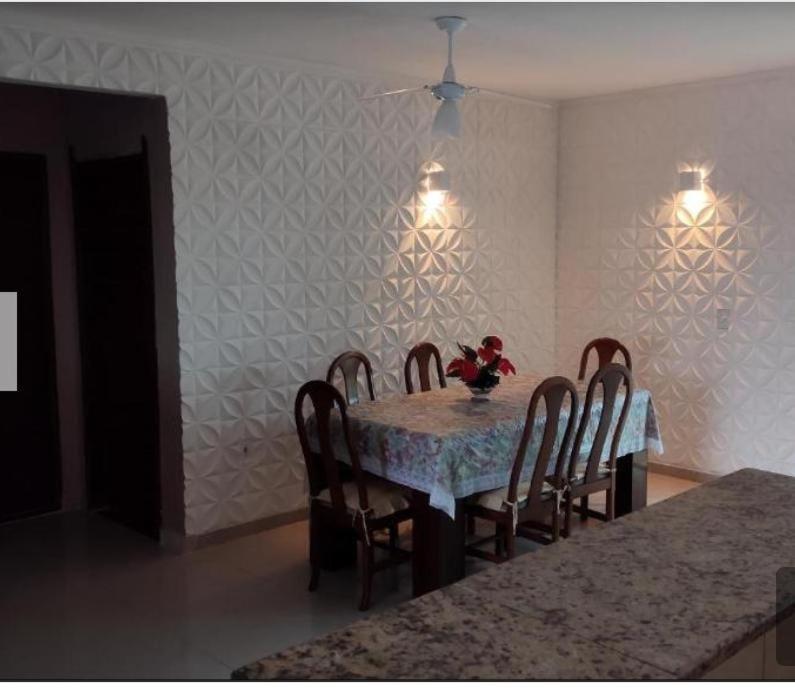 大伊瓜巴Estrela de Iguaba的用餐室配有桌椅和鲜花