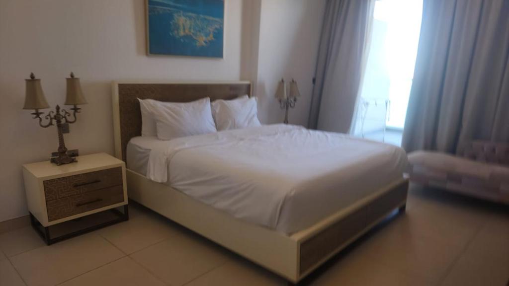 迪拜Azure Residences in Palm Jumairah的卧室配有白色的床和床头柜