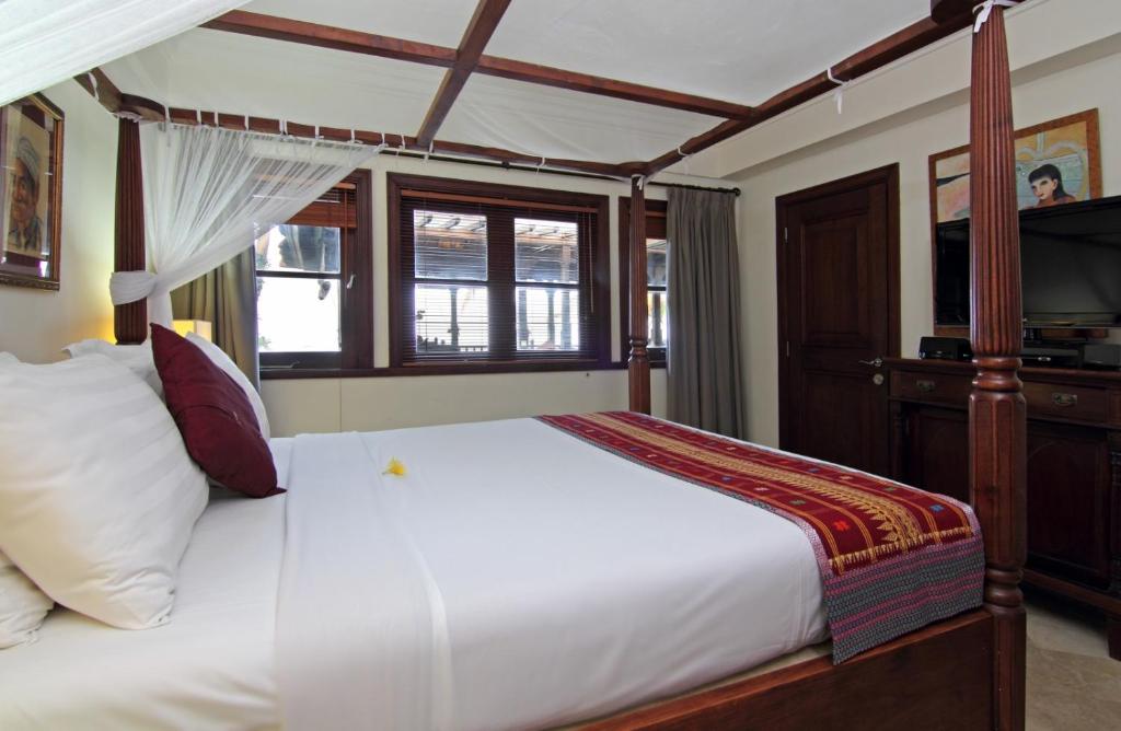 海神庙Villa Ocean的一间卧室配有一张带天蓬的白色床