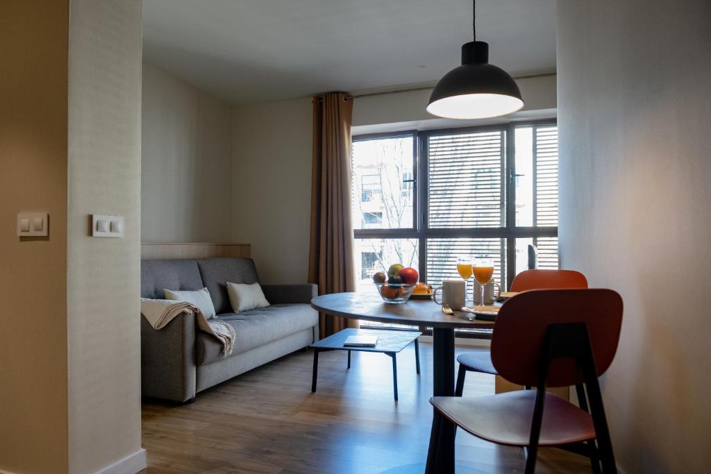 巴塞罗那MH城市公寓酒店的客厅配有沙发和桌子