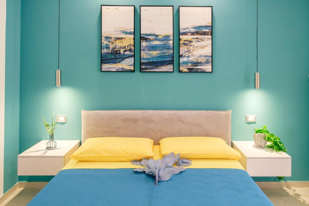 CastelsaracenoLeukòs Bed and Breakfast的蓝色的卧室设有一张黄色和蓝色的墙壁床