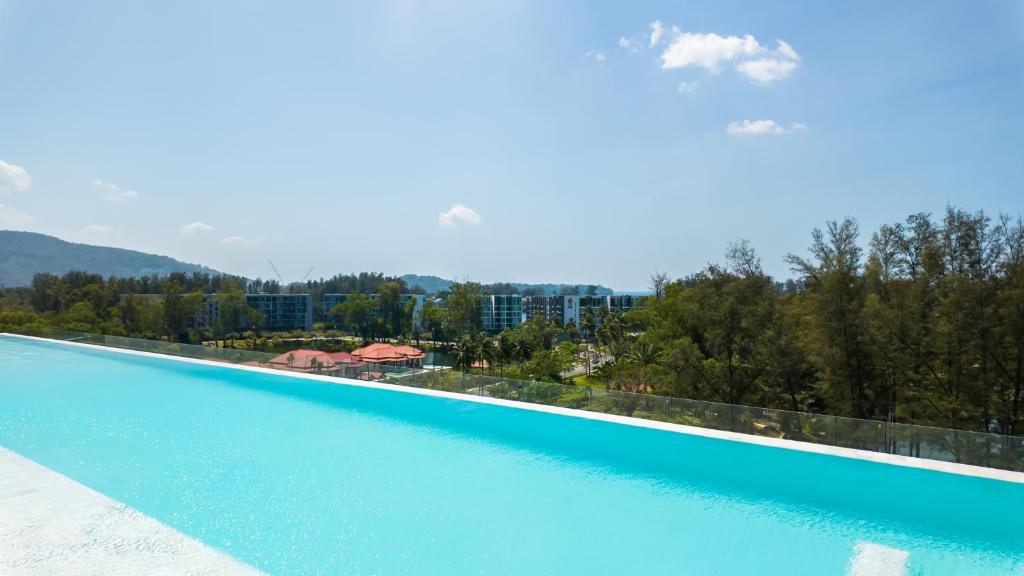 邦涛海滩Laguna Skypark Апартаменты的享有蓝色海水大型游泳池的景色