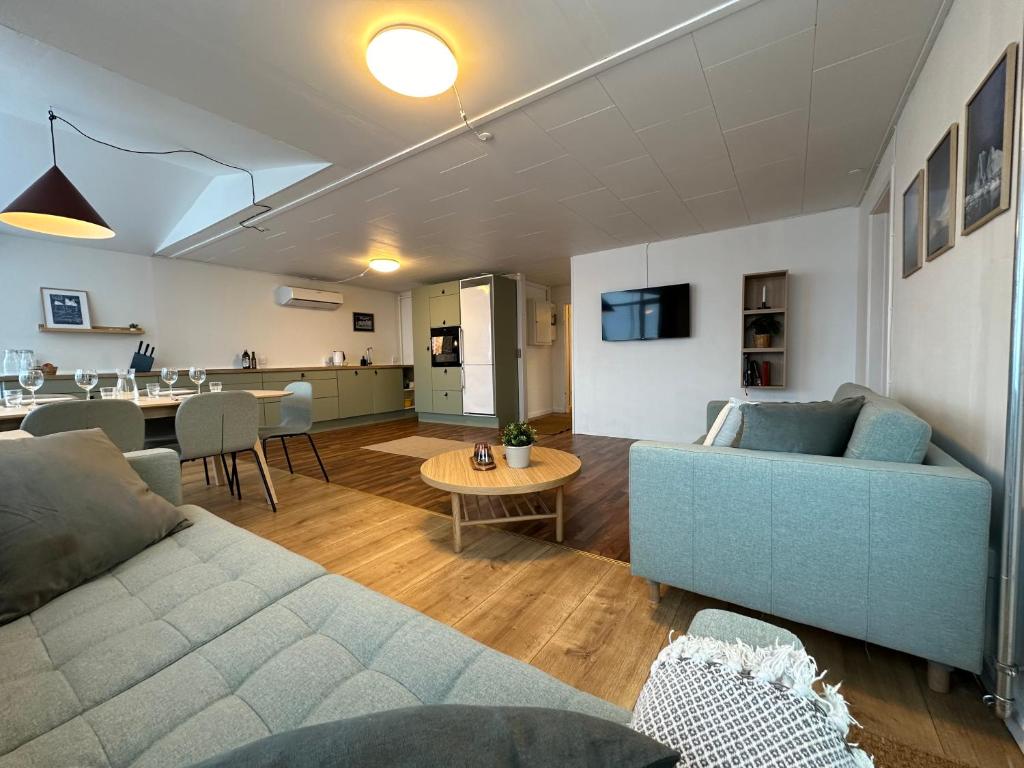 伊卢利萨特Det grønne hus med isbjergsudsigt的客厅配有沙发和桌子