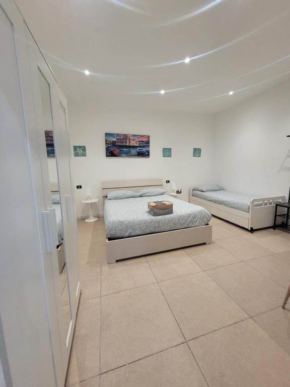 巴里House del Levante的白色的客房配有两张床和镜子