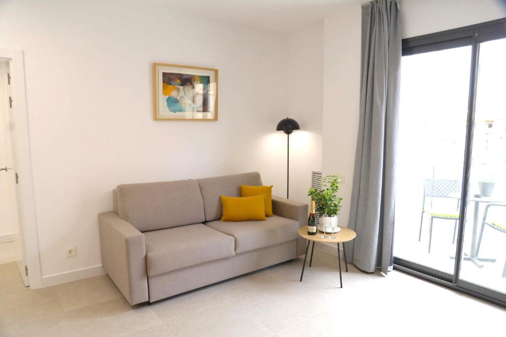 巴塞罗那柯瑟尔德瑟特科斯莫公寓 - 大学广场的客厅配有沙发和桌子