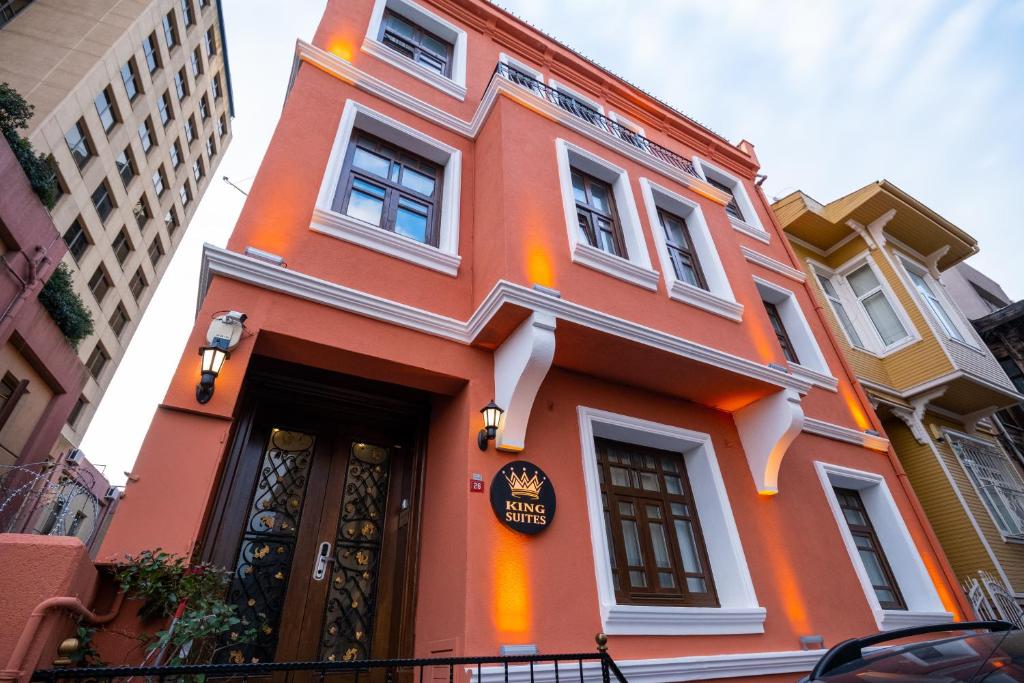 伊斯坦布尔King Suites Beşiktaş的一座橙色的建筑,上面有标志