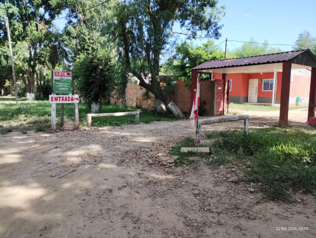 ClorindaCamping Caperucita Roja的土路前有标志的建筑物