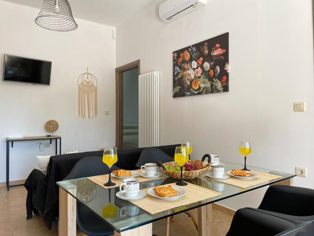阿尔戈斯托利翁Michael's House - Argostoli的用餐室配有带食品和酒杯的桌子