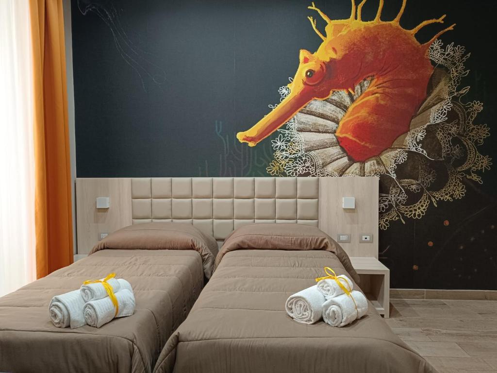 那不勒斯斯可丽齐酒店的墙上画画的房间里设有两张床
