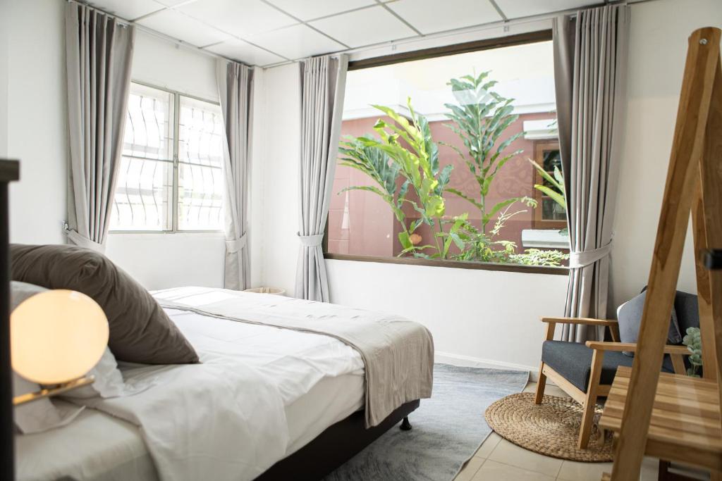 Ban Khlong Pha OngThe Golden Room - Suvarnabhumi的一间卧室设有一张床和一个大窗户