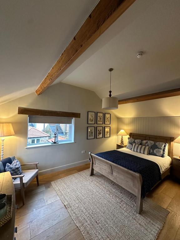 阿尔恩茅斯The Red Lion Inn Alnmouth的一间卧室设有一张大床和一个窗户。