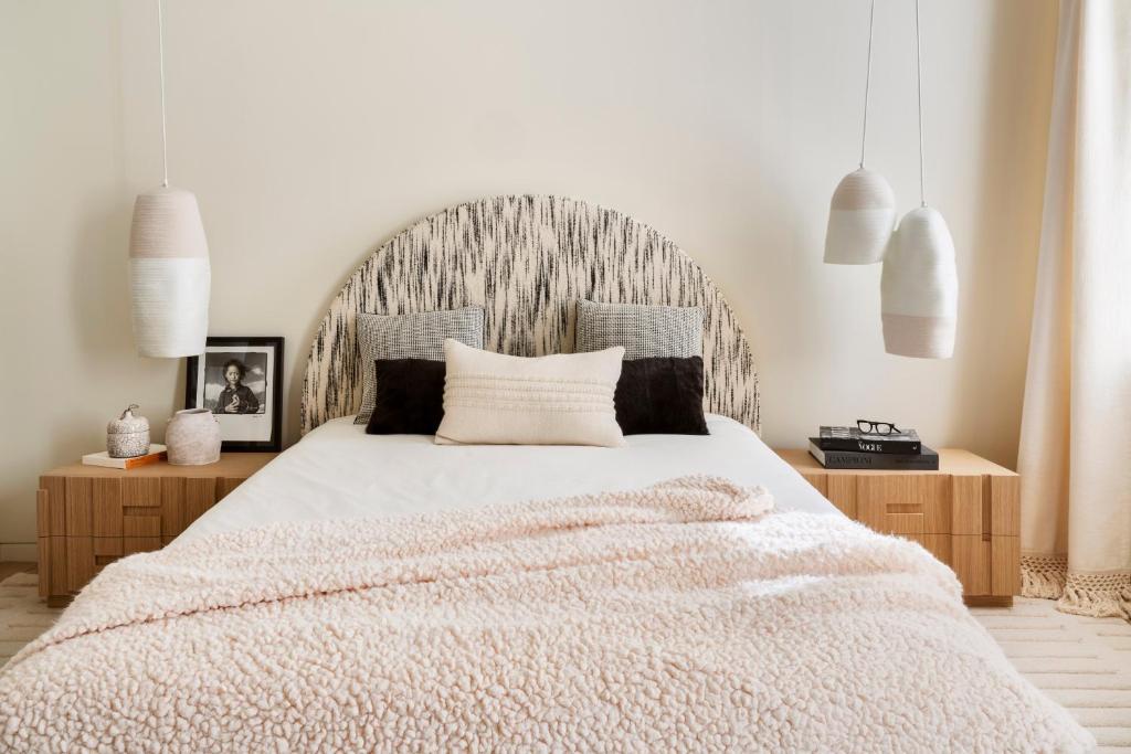 拉古莱特Tunisia la goulette的卧室配有一张白色大床和木制床头板