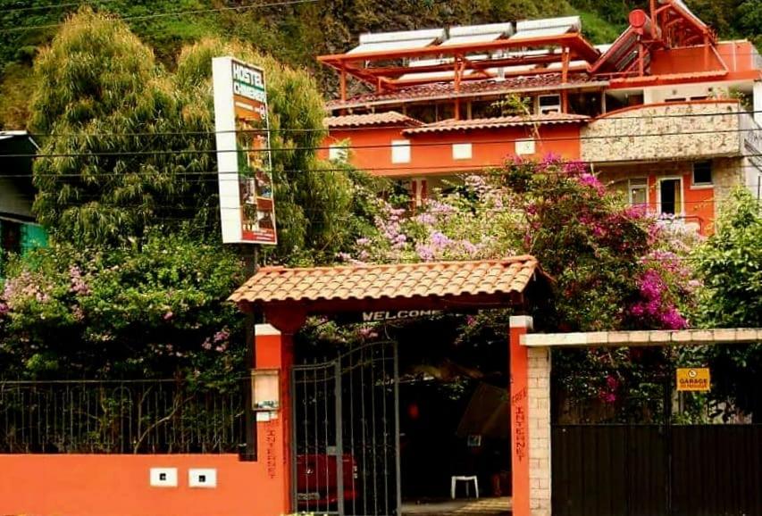 巴尼奥斯Hostal Chimenea的一座橙色的建筑,前面有一个门