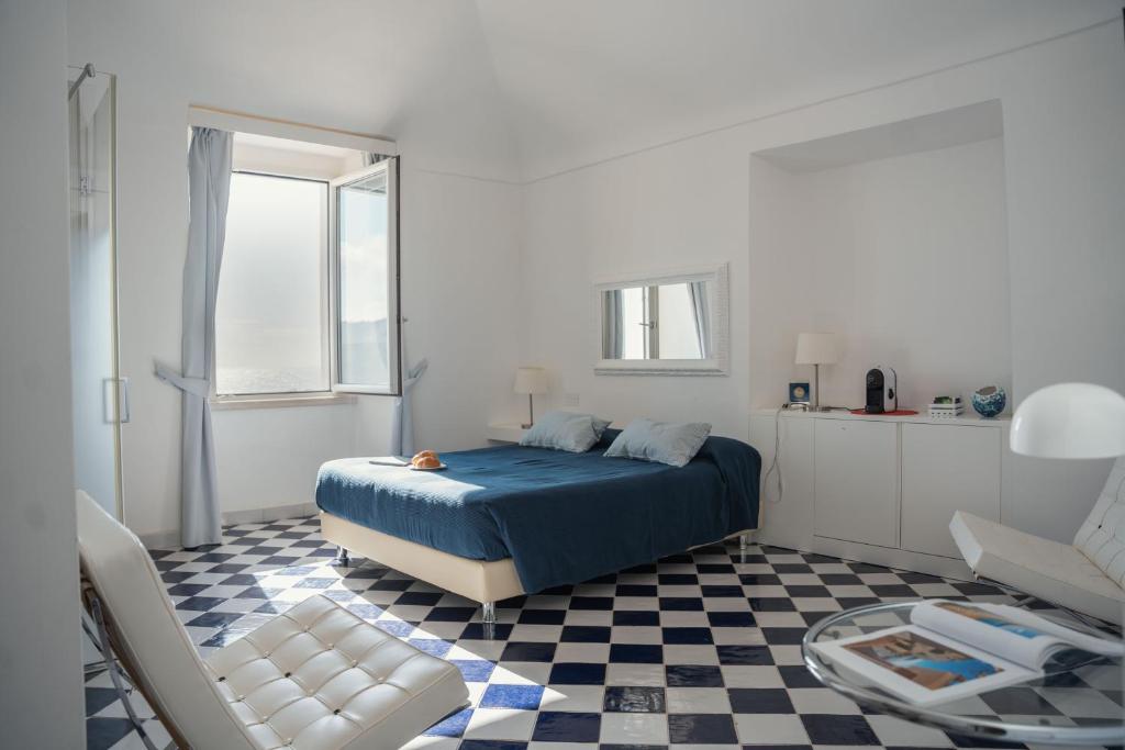 斯佩隆加Ganimede Centro Storico的一间卧室设有一张蓝色的床,铺有 ⁇ 格地板