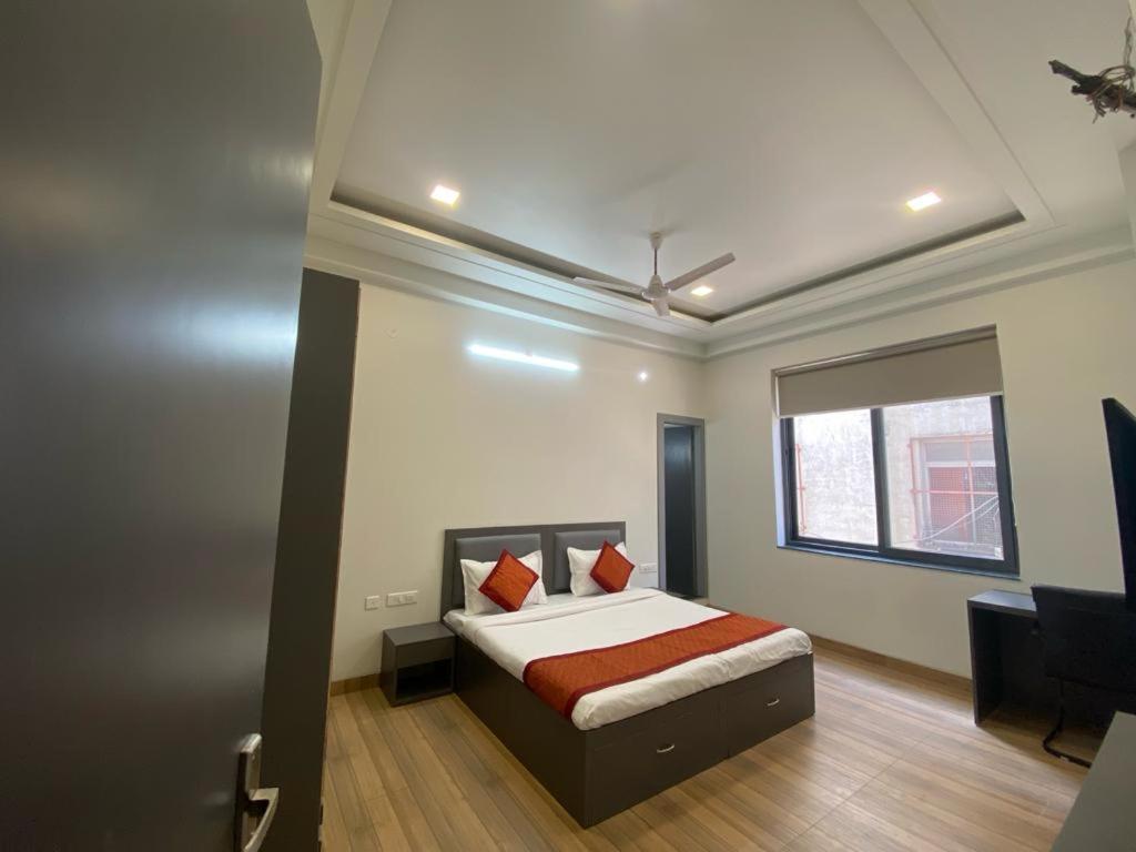 斋浦尔hello Namaste India-Elite的一间卧室配有一张床、一张书桌和一个窗户。