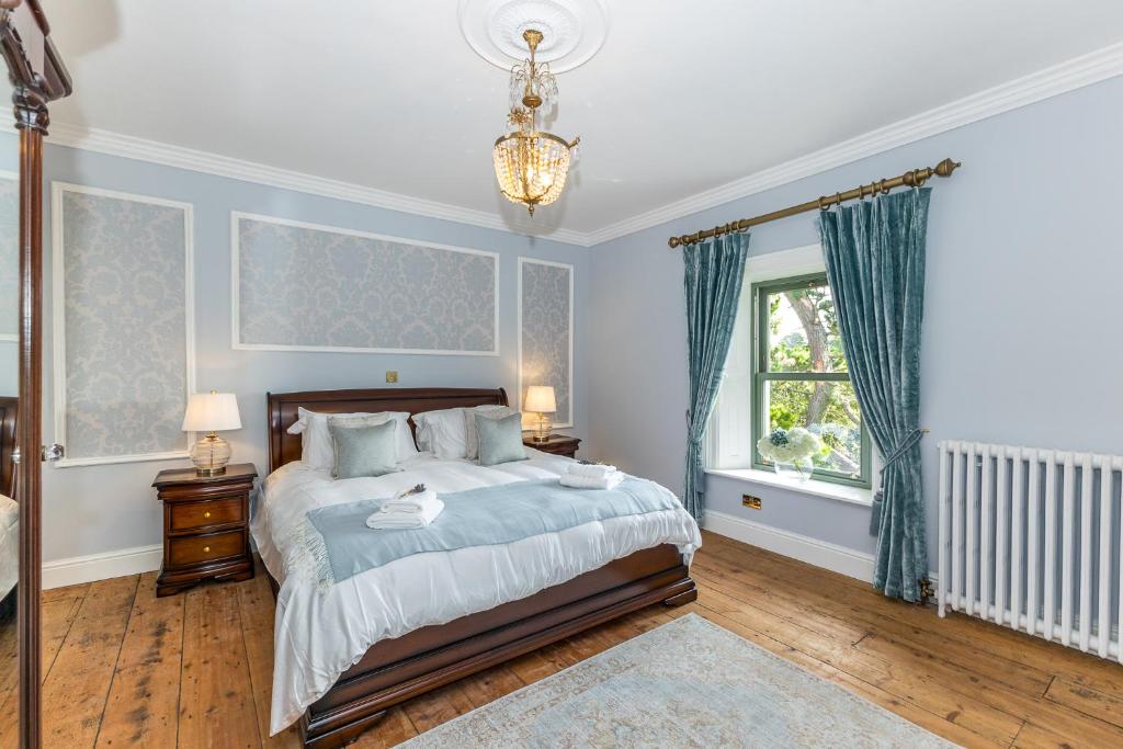 DonaghmoreMacepool的一间卧室配有一张蓝色墙壁的床和一扇窗户