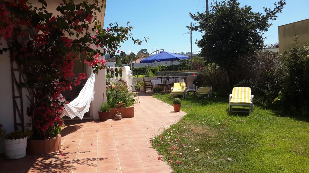 埃斯莫里斯Casa Lagoa Verde的庭院里种有椅子和鲜花