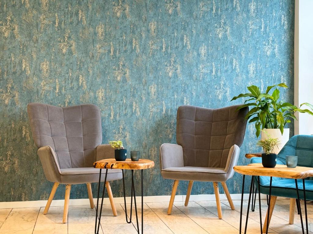 多特蒙德NP Hotel Königshof的墙上有两把椅子和一张桌子