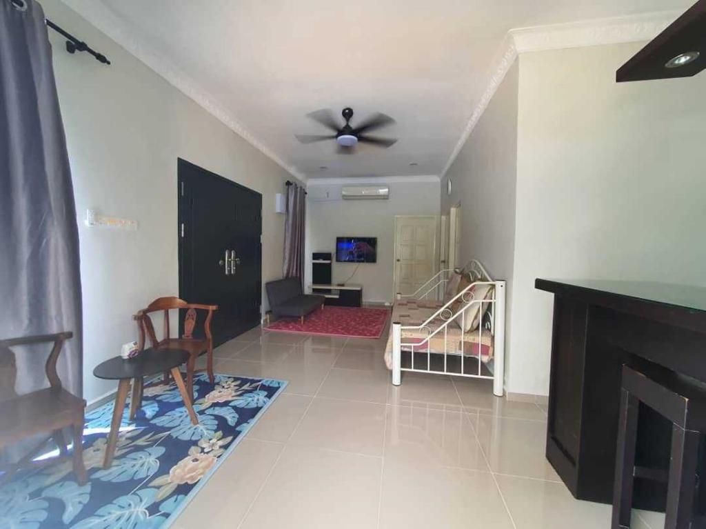 Hutan MelintangLa Familia Homestay Bagan Datuk的一间带吊扇的客厅和一间客厅。