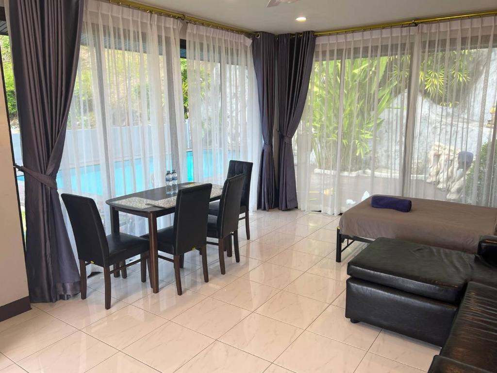 卡伦海滩Blue Sky Villa的客厅配有桌椅和1张床