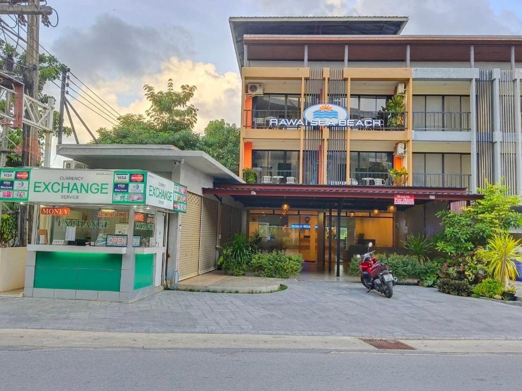 普吉镇Rawai Sea Beach的停在大楼前的摩托车