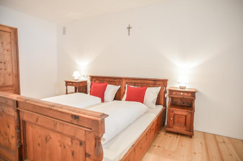 拉古多Tholer Ferienwohnung 2的一间卧室配有两张带红色枕头的床