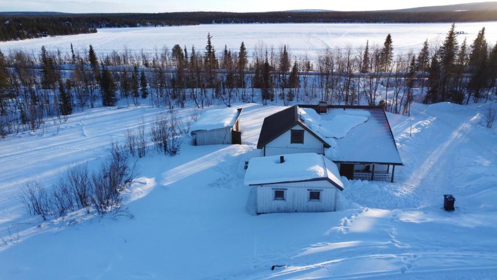 基律纳Arctic Cottage Kiruna, Groups的雪地里的房子