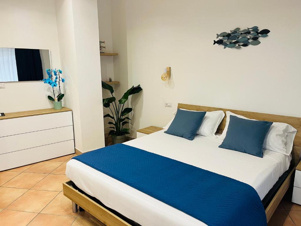 塔尔奎尼亚Casa Saline的一间卧室配有一张带蓝色和白色枕头的床