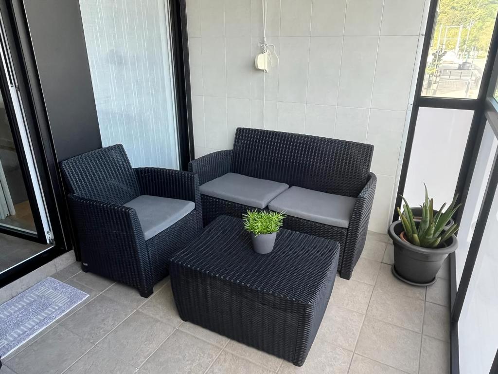 奥利奥Apartamento moderno y acogedor ideal familias的阳台配有2把藤椅和1张桌子