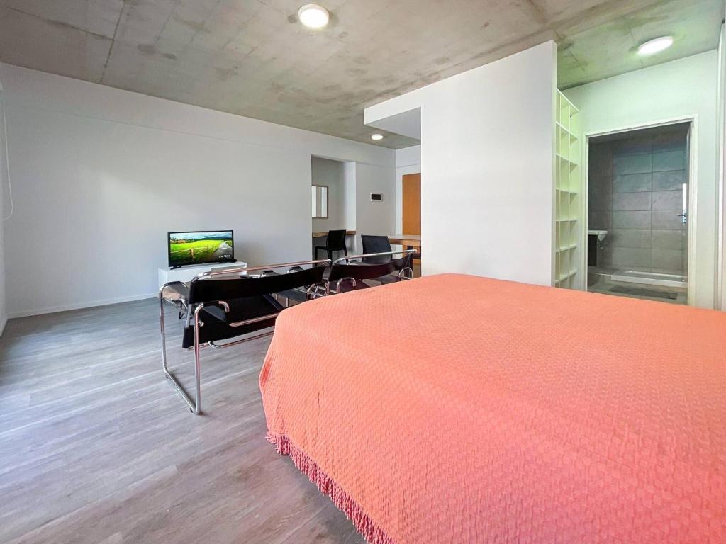 布宜诺斯艾利斯Charming Studio in the Heart of La Boca - Caminito的一间卧室配有红色的床和一张书桌