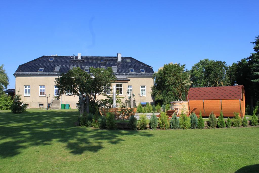 普伦茨劳Ferienwohnung im Gutshaus Mühlhof的前面设有花园的大房子