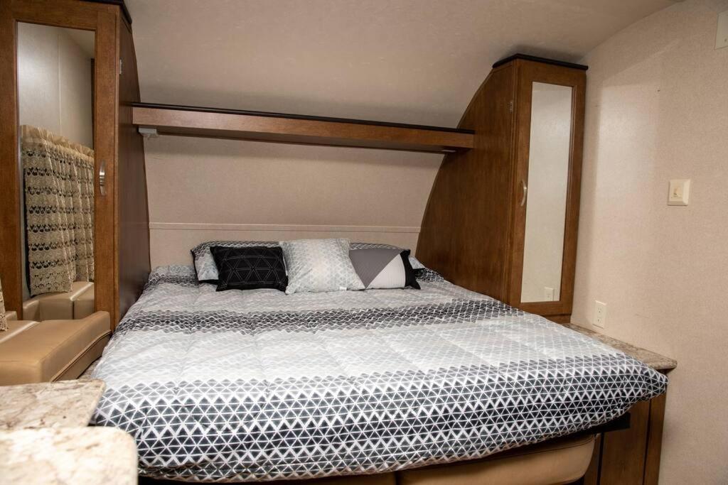 尼斯维尔Quiet Cozy Camper的一间卧室配有一张木架床