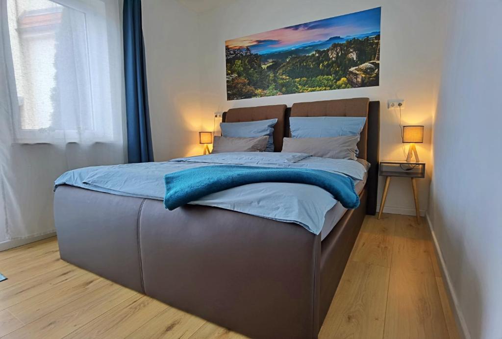 柯尼希施泰因易北Moderne Ferienwohnung im Herzen von Königstein的一间卧室配有一张带蓝色床单的大床