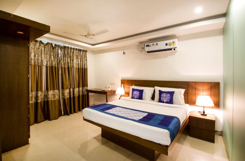 商沙巴Rainbow International Hotel Airport Zone Shamshabad的一间卧室,卧室内配有一张大床