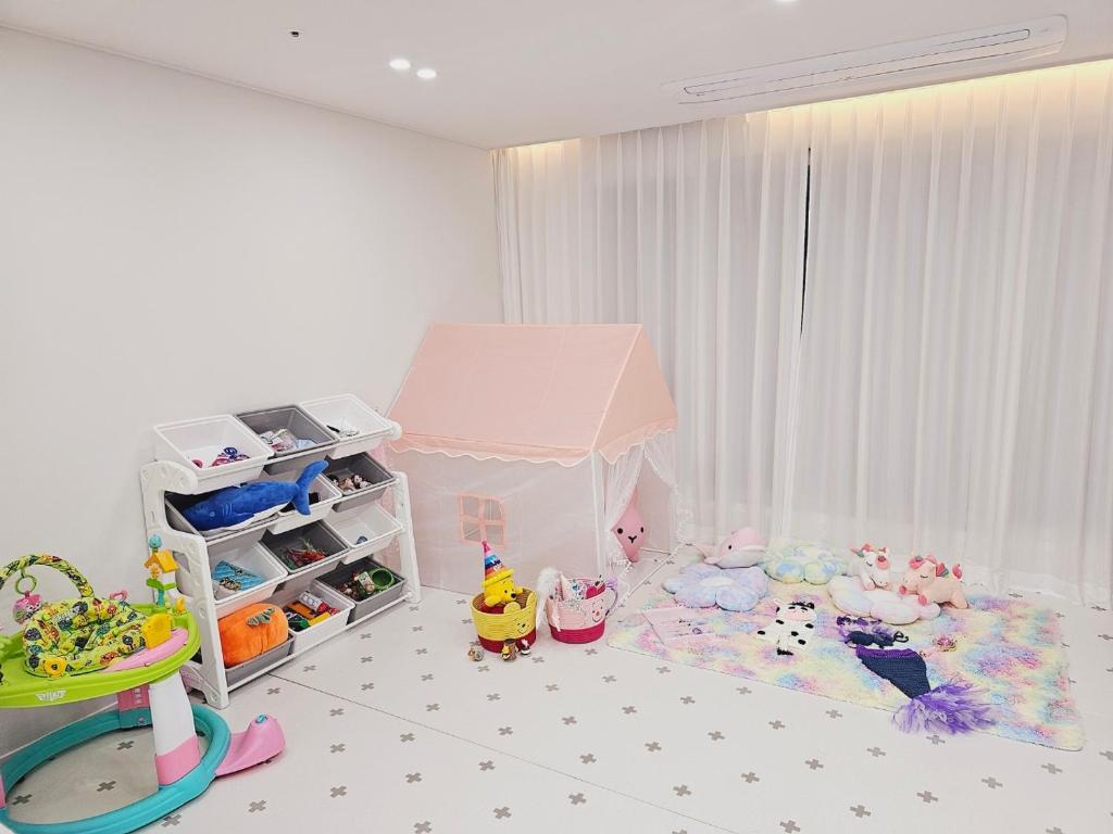 富川市Sosaeul Avenue kids room, family room的儿童卧室,配有粉红色的帐篷和玩具