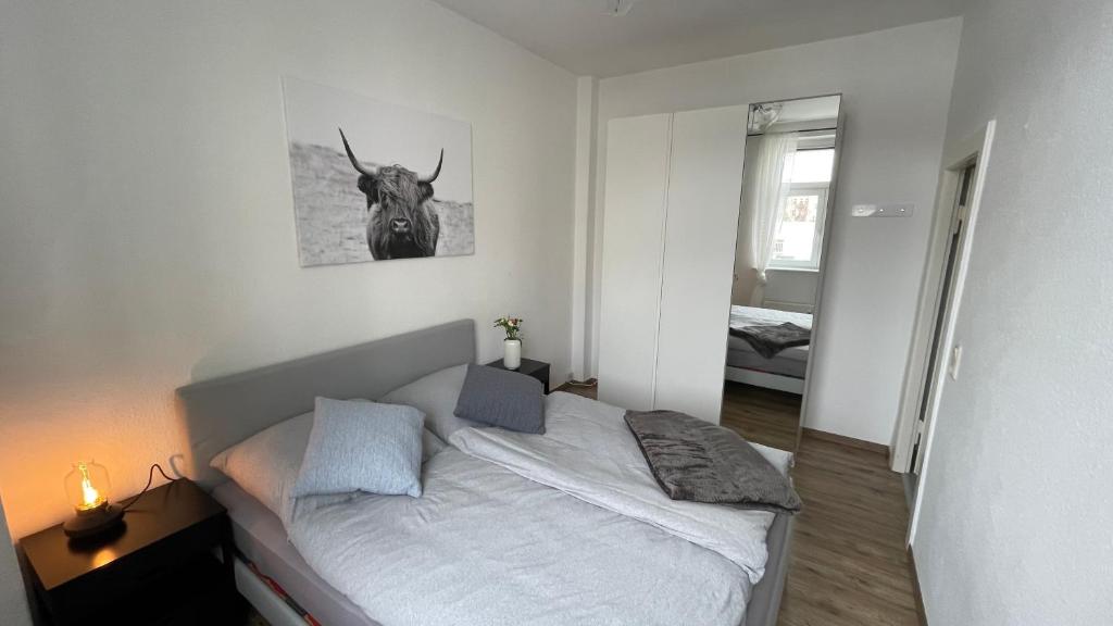 莱比锡Charmante Wohnung in der Südvorstadt的卧室配有一张睡床,墙上挂着牛头