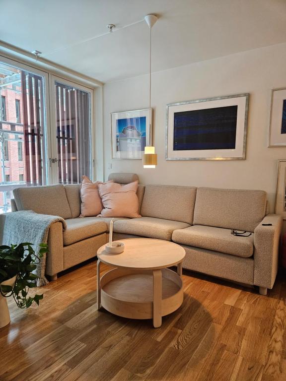特隆赫姆Ny og moderne leilighet, midt i byen1的客厅配有沙发和桌子