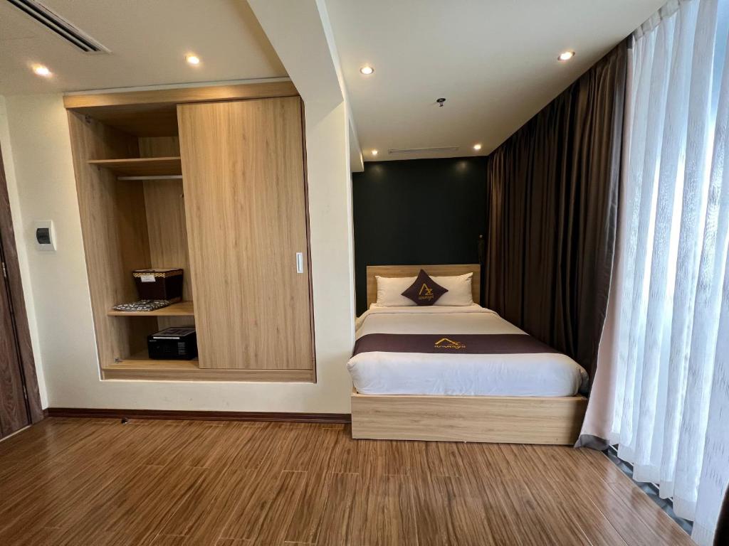 海防Azumaya Hotel Hai Phong的一间小卧室,配有一张床和镜子