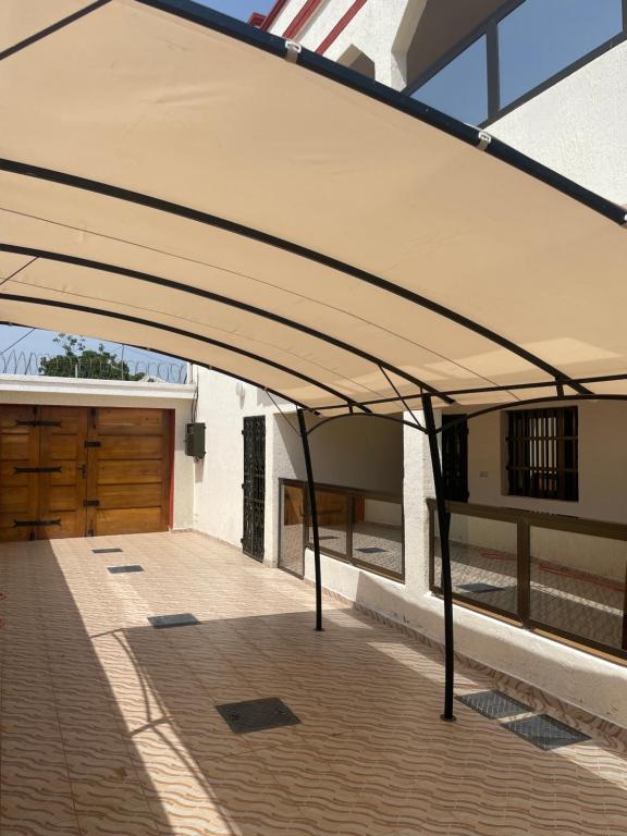 BéWendyla Luxury's的遮篷,遮盖在带车库的房屋车道上