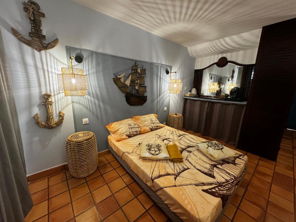 拉特里尼泰La Caravelle - Agréable studio vue sur mer avec piscine的卧室配有一张床,墙上设有镜子