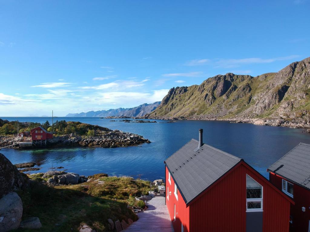 巴尔斯塔Cabin in Lofoten with spectacular view的水体上的一个红色房子